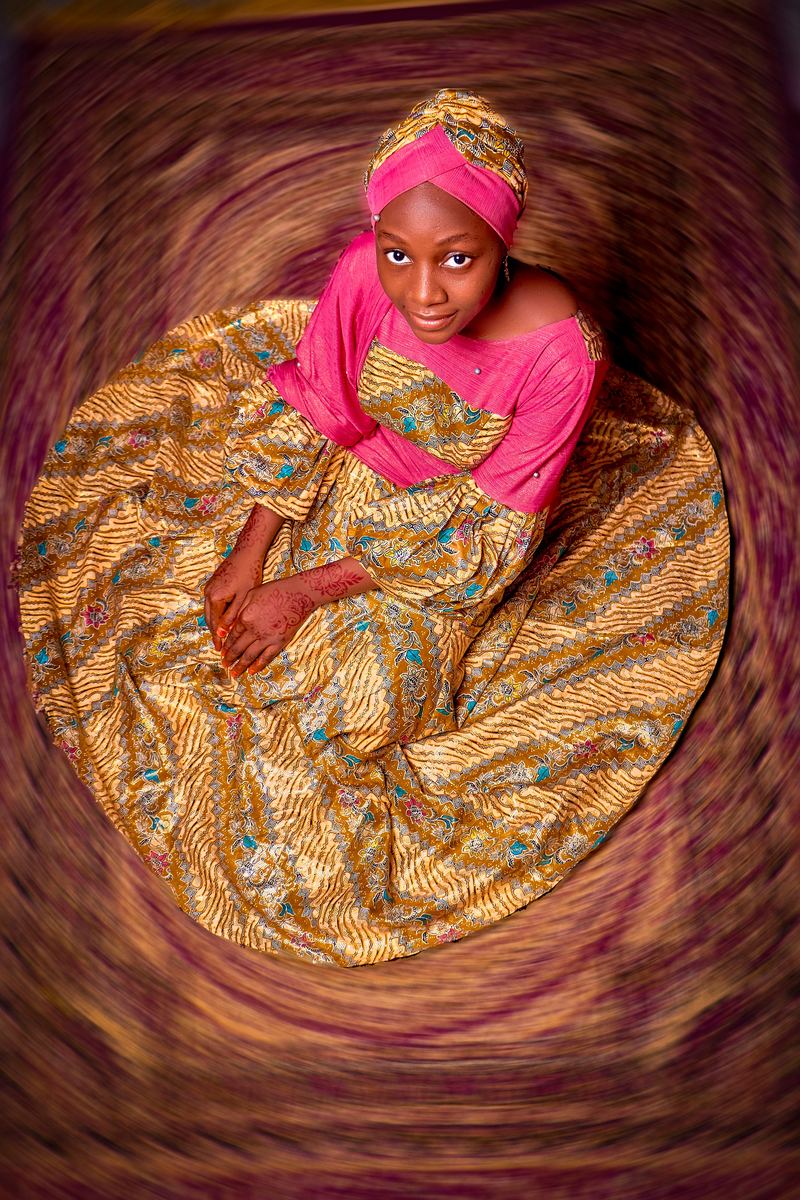 Voluminous golden wax skirt spread out like a blooming flower, seen from above